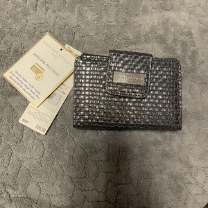Adrienne Vittadini Silver Pebbled Wallet. 
New. 10 Slot cards & 2 zipper sides.